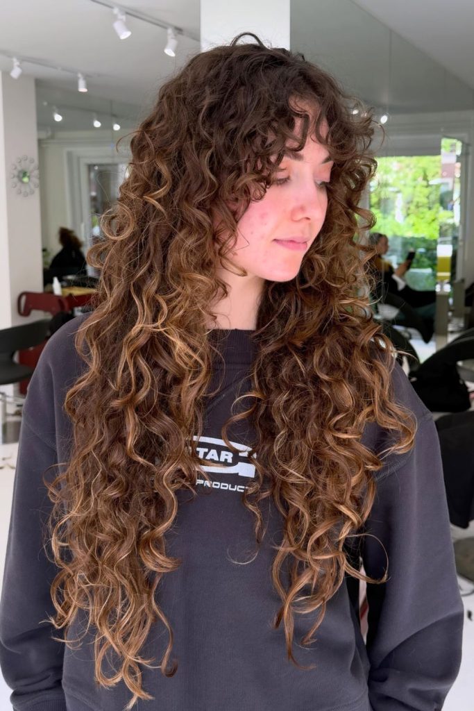Curly Long Layers With Soft Side Fringe